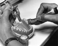 Student practices teeth cavity fillings