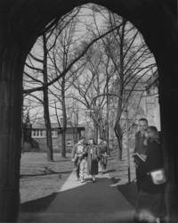 Students walk under Mary Chisholm Painter Arch