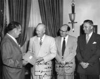 T. Keith Glennan hands report to Dwight D. Eisenhower