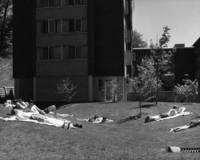 Students sunbathe outside their dormitory