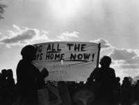 Students hold a sign up protesting the Vietnam War
