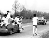 Hudson Relay runner accompanied by teammates in car