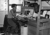 Student studies at her desk in her dormitory room