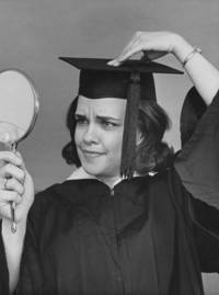 Woman adjusts her hat before commencement